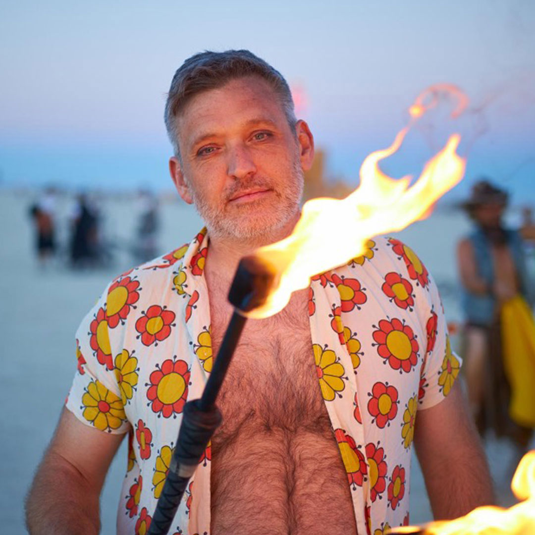 Physics holding a fire torch at EXXXOTICA.