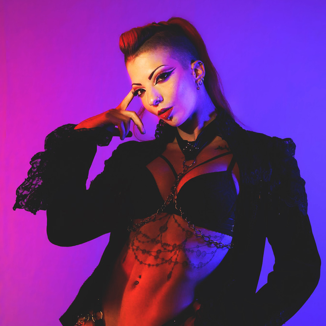 Vampiress posing in gothic stagewear for her aerial fire performance on the EXXXOTICA Main Stage