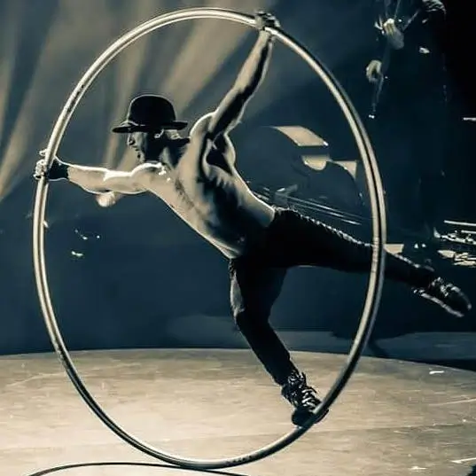 Object Man performing inside a Cyr wheel for Centered, Tender, Sexy, Sauvage Men at EXXXOTICA.